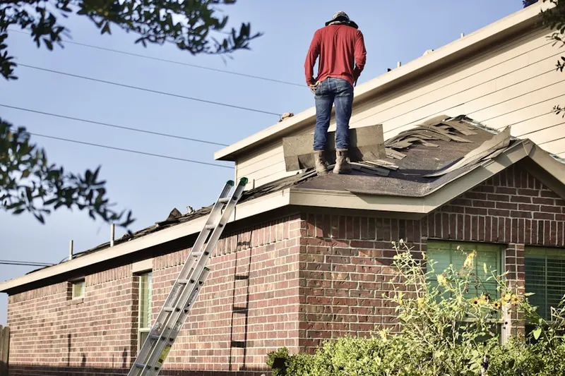 Professional roofer working on a residential roof in Ostrander